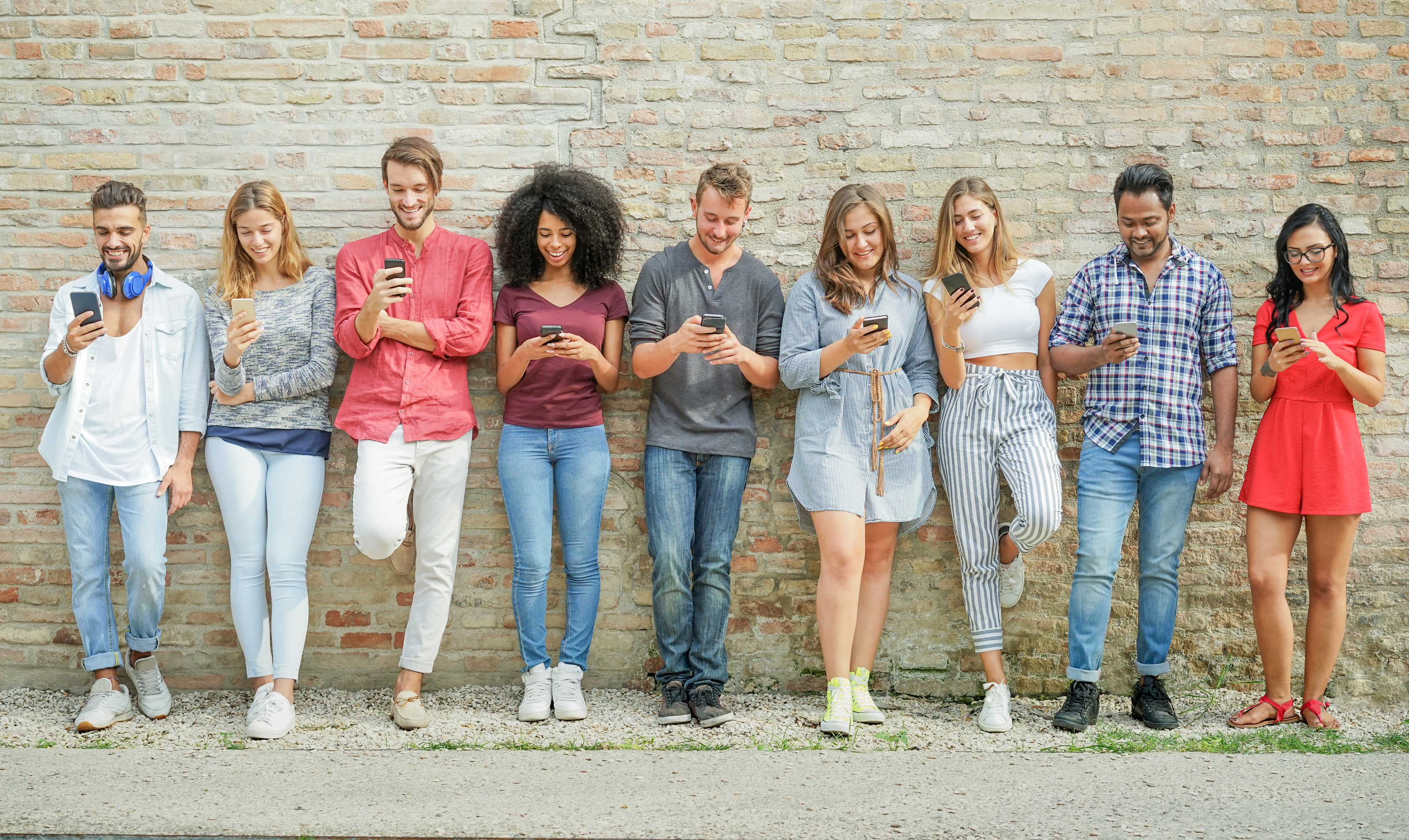 Teens with a shocked expression looking at their phones